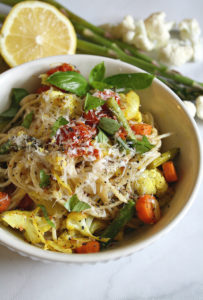 Bowl of Winter Pasta filled with gluten free noodles, cauliflower, asparagus, carrots and basil