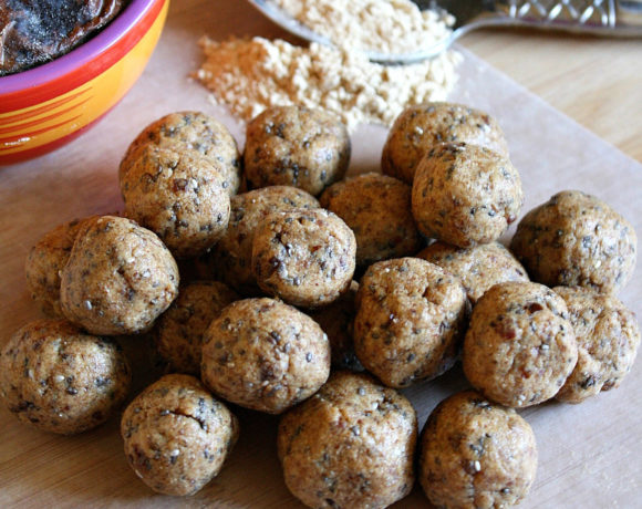 Cutting board with protein balls, maca powder, and dates