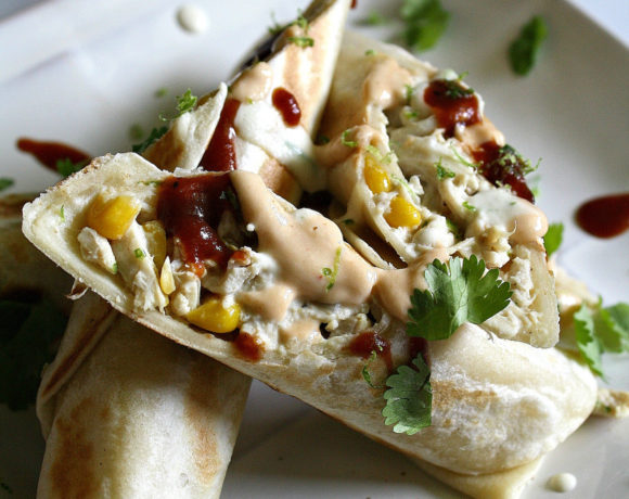 Plate with chicken and corn filled tortillas with lime, sriracha, dairy free cream cheese