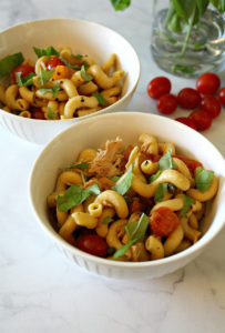 White bowls with gluten free pasta, Summer veggies, tuna, basil