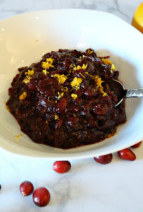 White bowl with cranberry sauce with orange