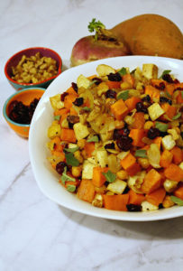 White bowl filled with sweet potatoes and turnips on marble surface